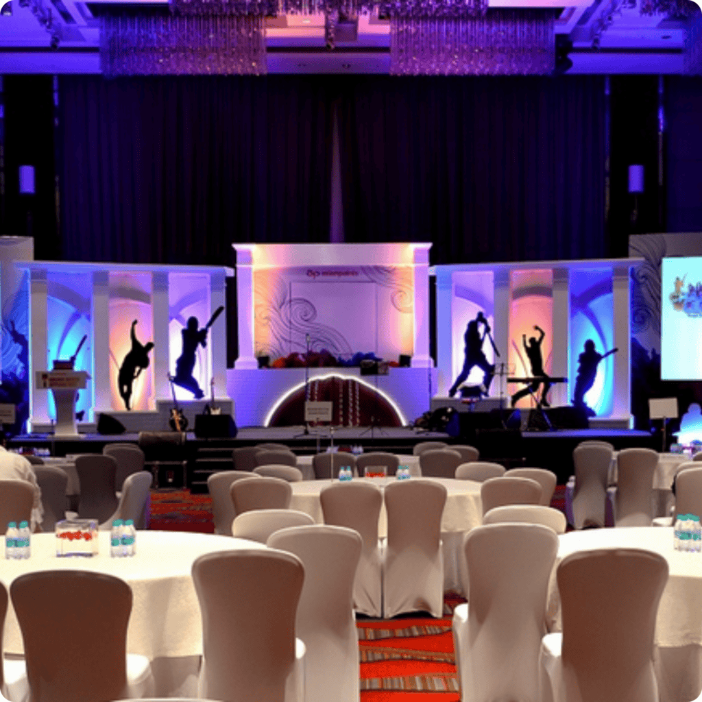 Elegant event stage with dance silhouettes and seating arrangement for a corporate or social event.